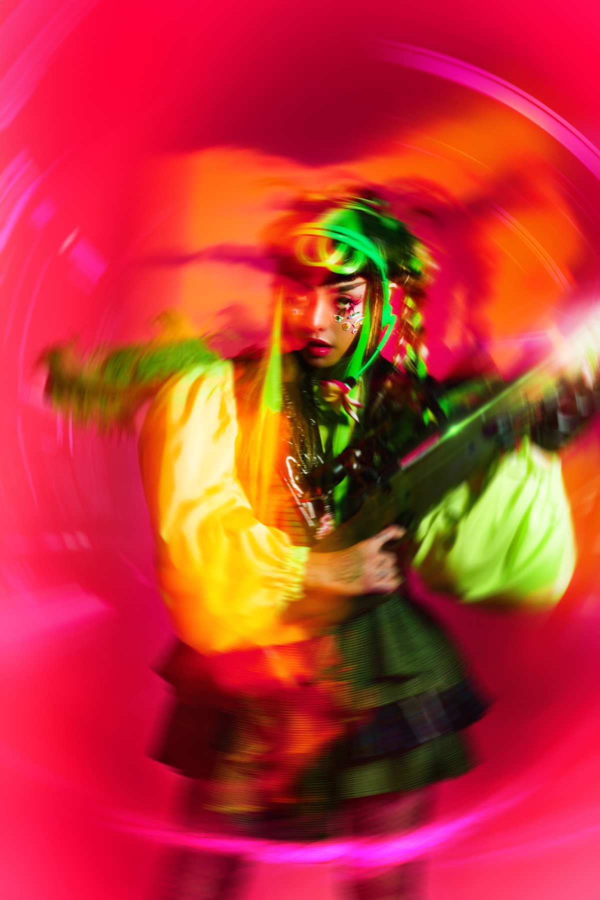 Pyra in a vivid pink, orange and green motion-blurred press portrait